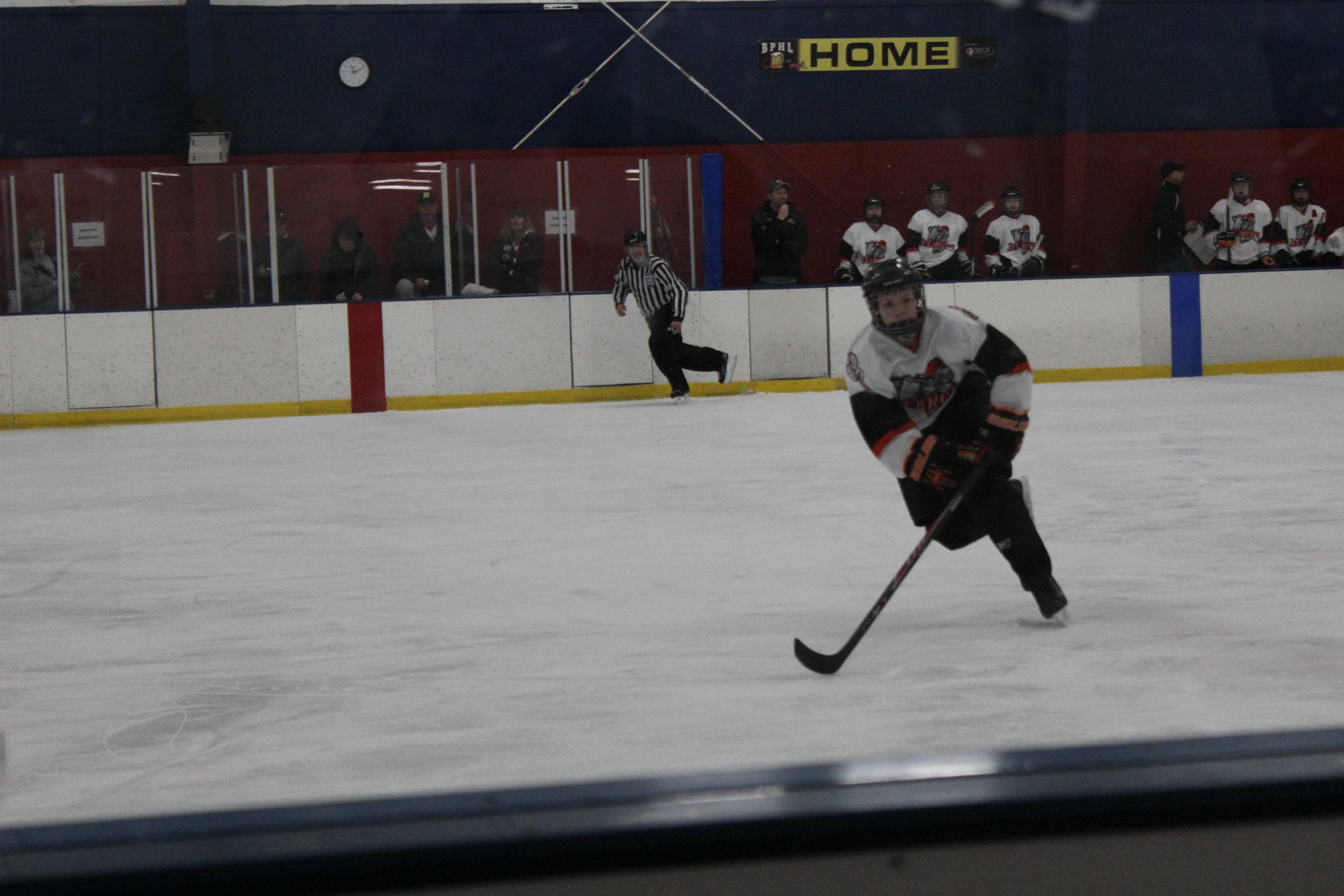 Deanna Dymond skates across the ice rink during hockey practice. Photo by Brooke Riley